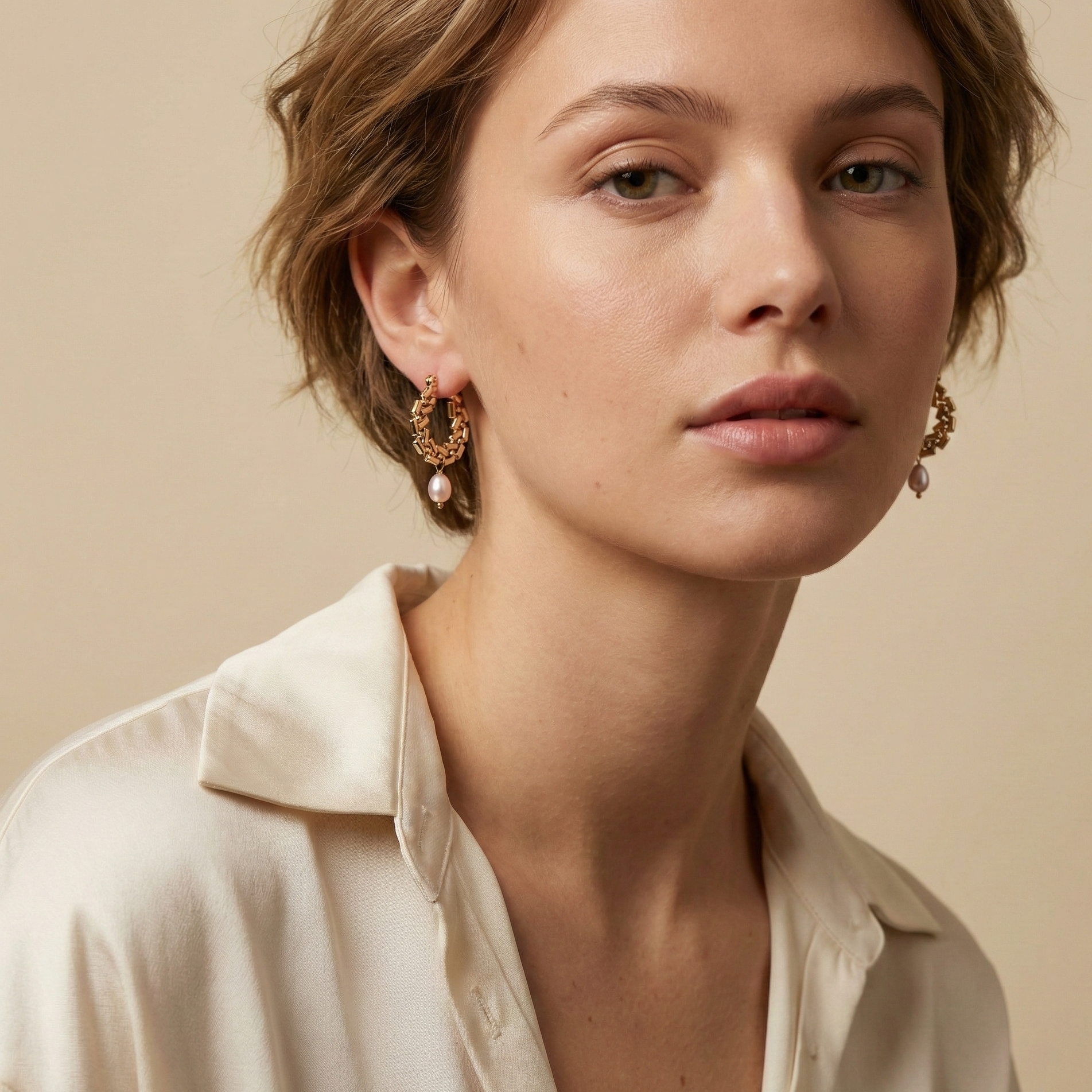Gold drop earrings featuring a sleek 2.5cm structured gold bar suspended with a lustrous 6mm oval champagne freshwater pearl. Minimalist 18k gold plated jewelry design