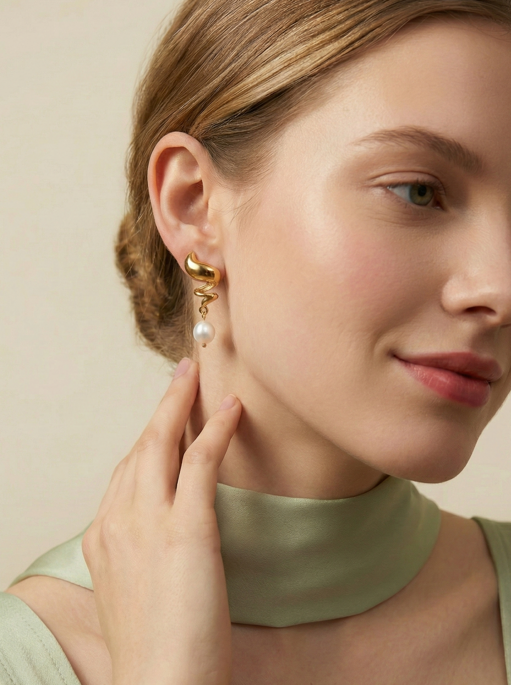 Side view of Alizee earrings showing the organic gold texture and unique baroque pearl shape. Water-resistant and hypoallergenic stainless steel design
