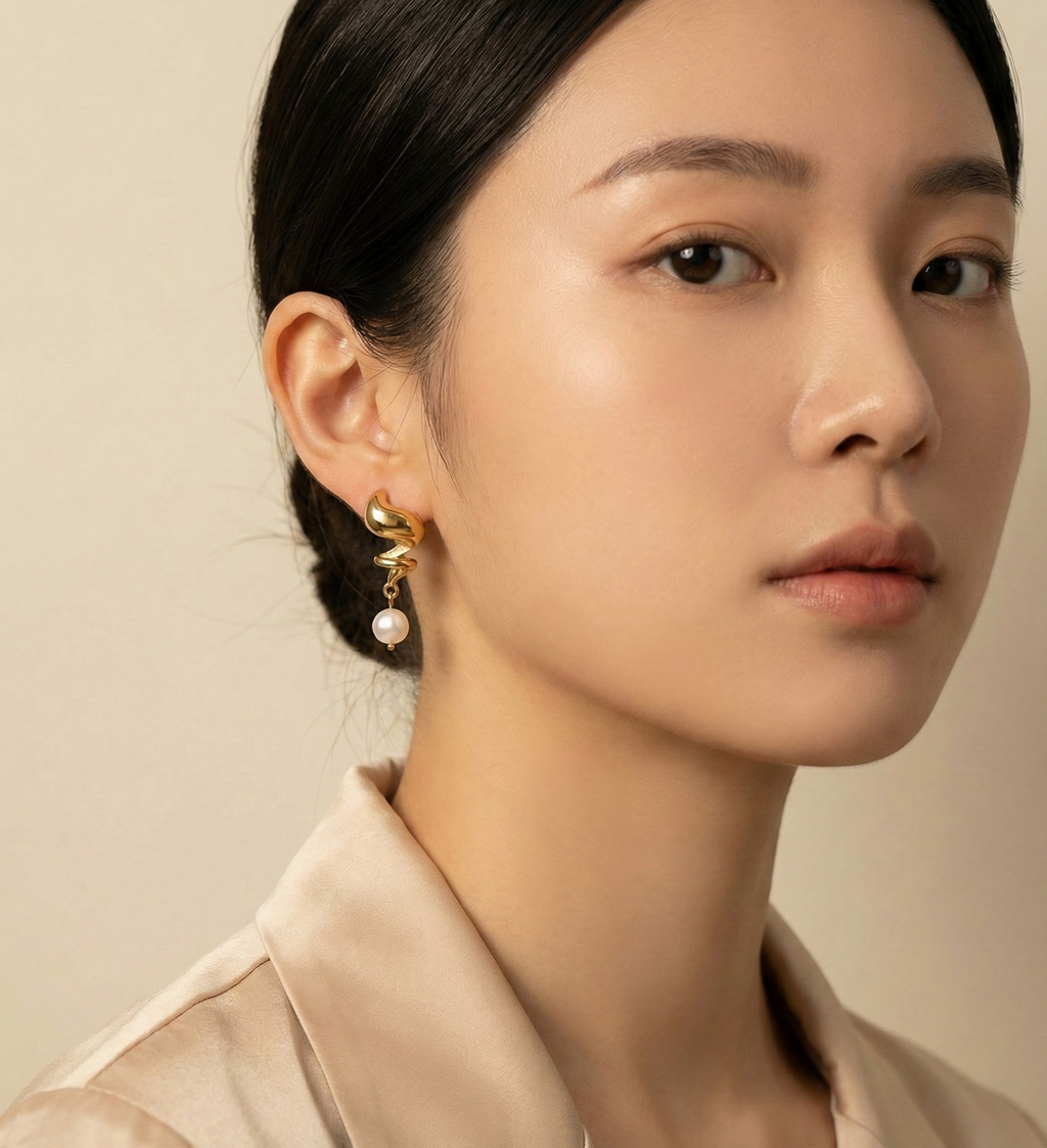 Side view of Alizee earrings showing the organic gold texture and unique baroque pearl shape. Water-resistant and hypoallergenic stainless steel design