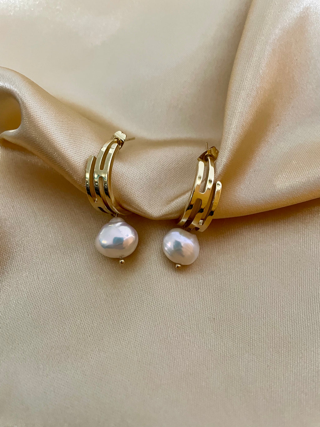 lustrous baroque freshwater pearls suspended from sleek polished hoops