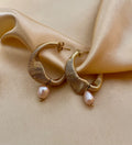 Gold hoop earrings with pink organic baroque pearl drops