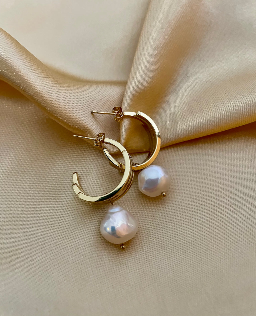 lustrous baroque freshwater pearls suspended from sleek polished hoops