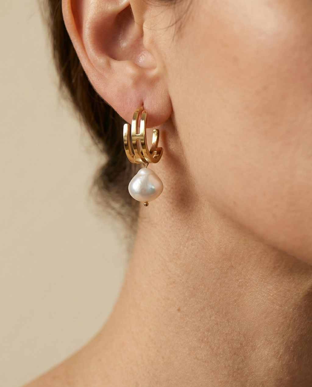 lustrous baroque freshwater pearls suspended from sleek polished hoops