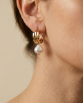 lustrous baroque freshwater pearls suspended from sleek polished hoops
