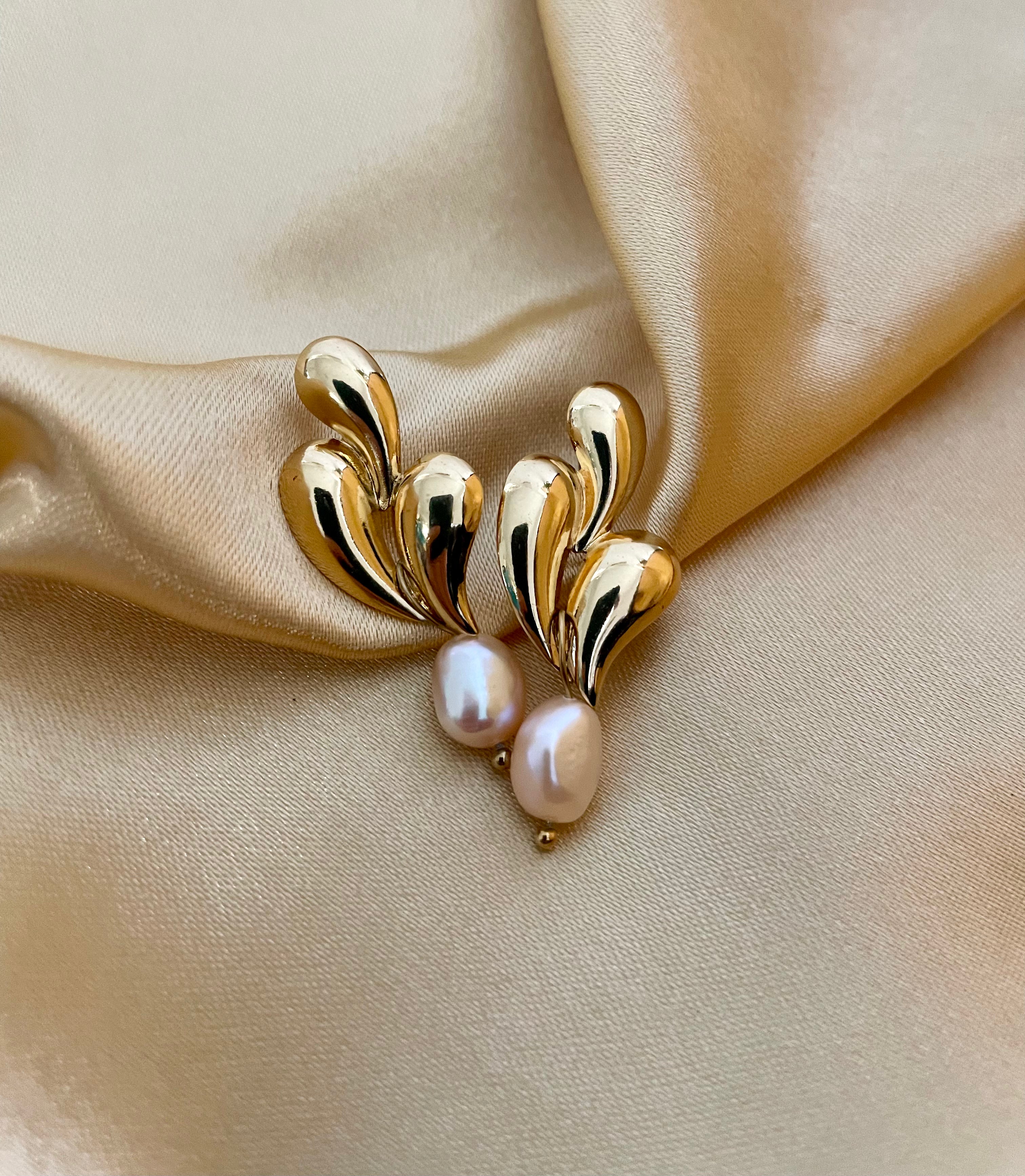 unique, organic-shaped gold earrings featuring lustrous pink oval pearl drops