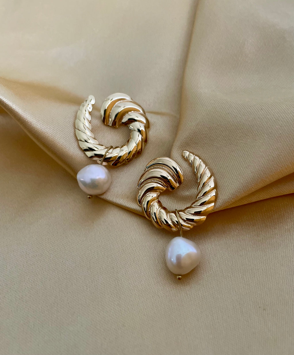 Close-up detail of the ribbed gold texture on the Miranda croissant hoops paired with a high-lustre AAA white baroque pearl.