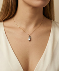 Organic grey baroque pearl necklace featuring a high-luster Keshi pearl suspended on a fine gold chain. Minimalist jewelry styling