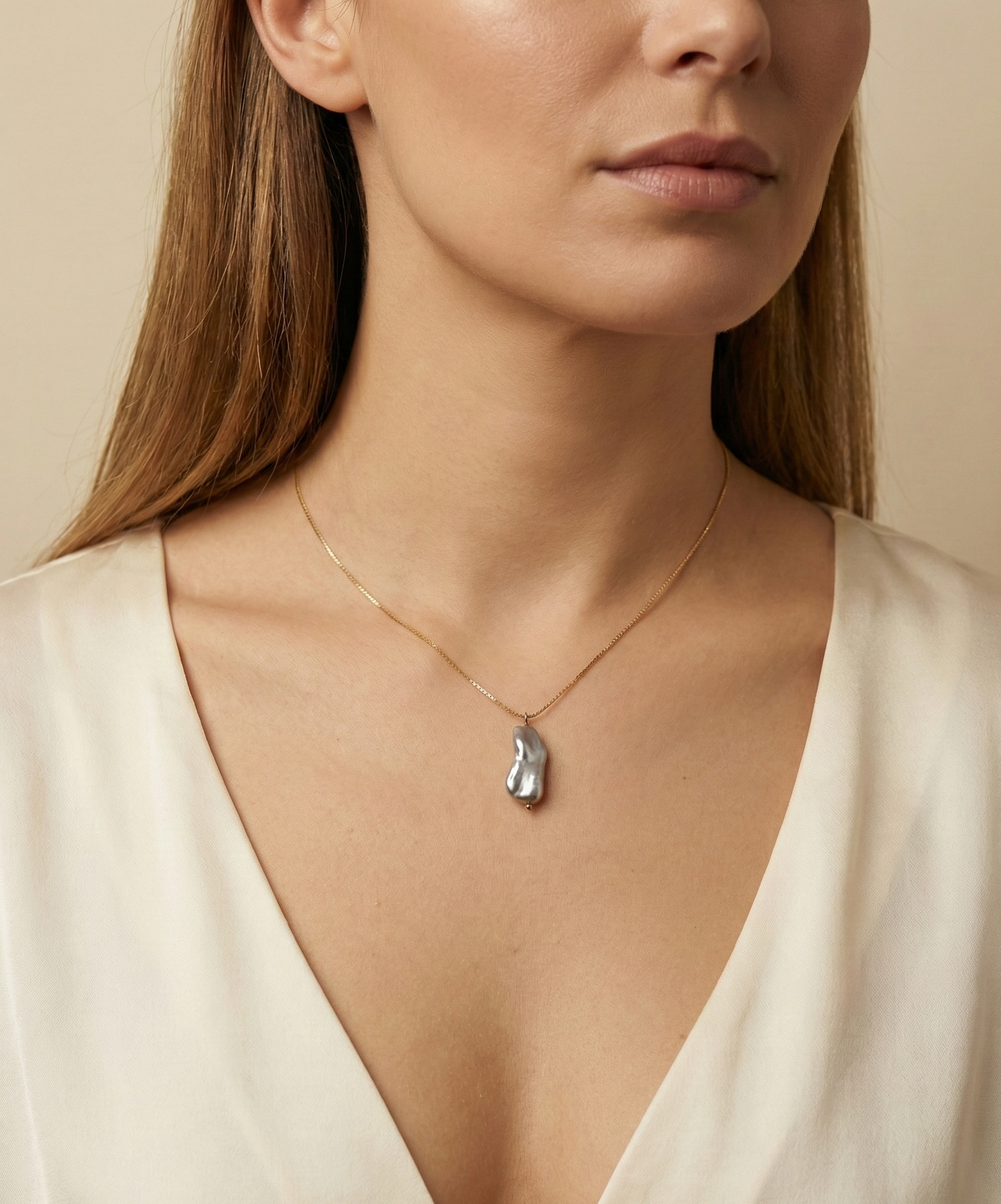 Organic grey baroque pearl necklace featuring a high-luster Keshi pearl suspended on a fine gold chain. Minimalist jewelry styling