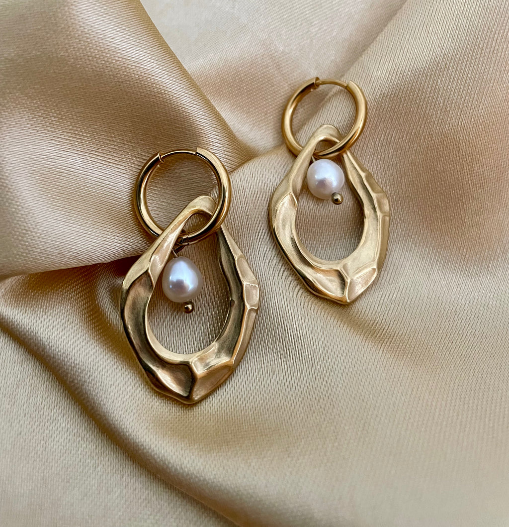 18k gold plated organic shape drop earrings featuring a lustrous white freshwater pearl, worn in a luxury editorial setting