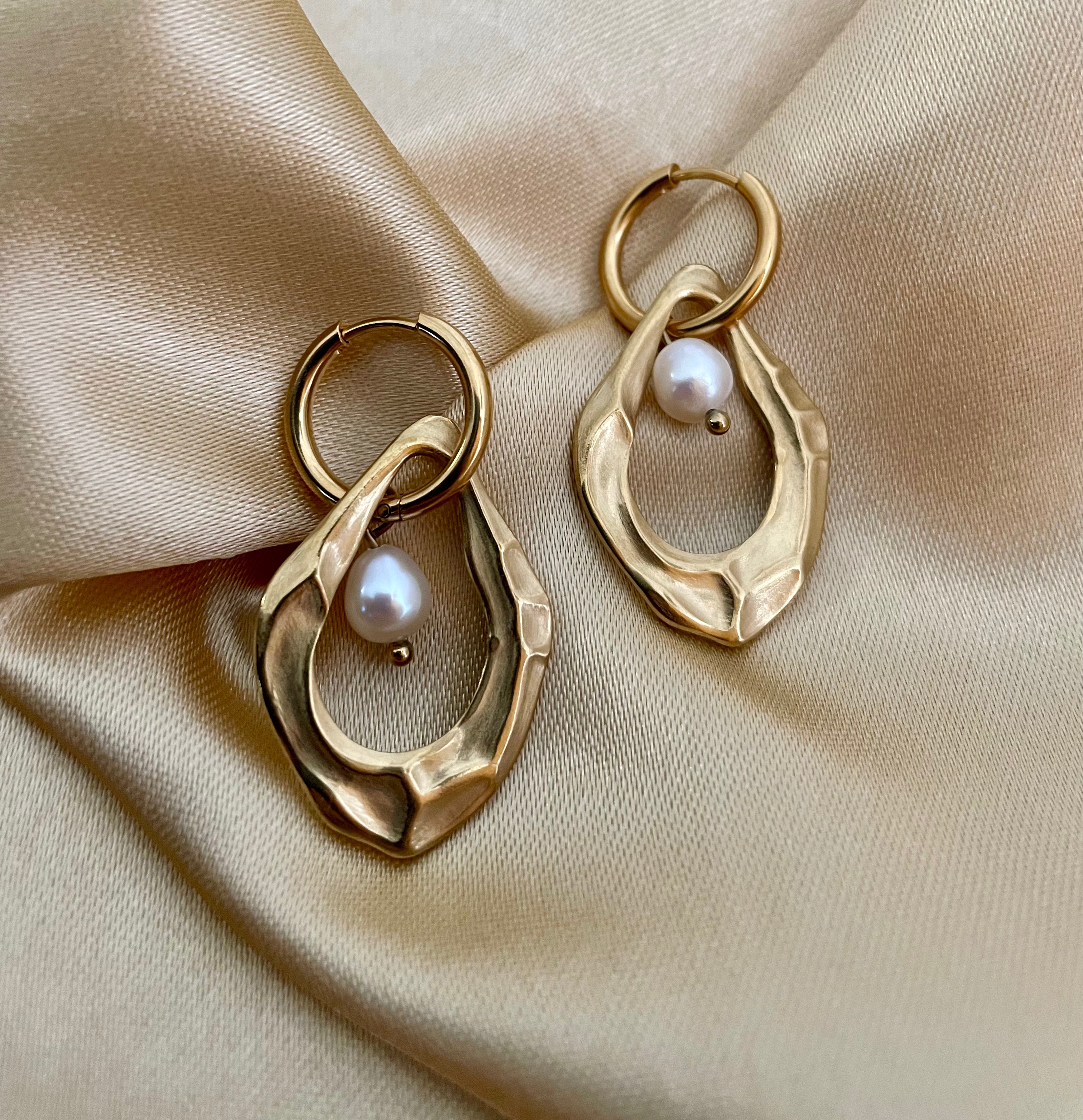 18k gold plated organic shape drop earrings featuring a lustrous white freshwater pearl, worn in a luxury editorial setting