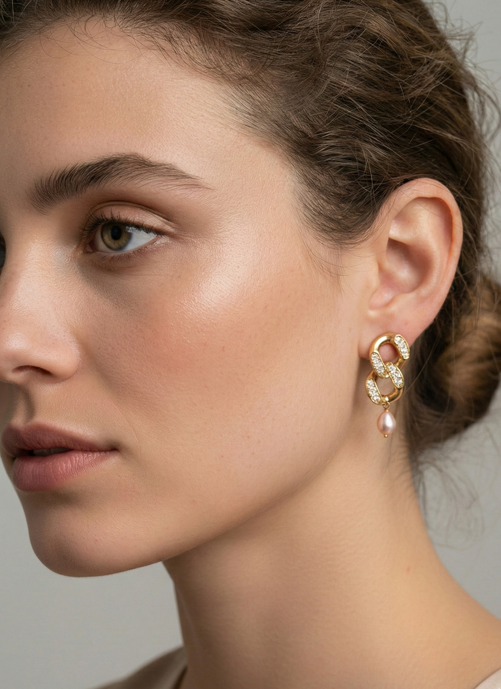 Woman wearing gold and diamond earrings with pink freshwater pearls